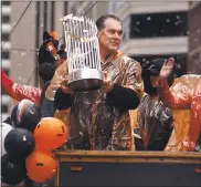  ?? PATRICK TEHAN — STAFF FILE PHOTO ?? Bruce Bochy holds the World Series trophy during the victory parade in San Francisco in 2014. His postseason winning percentage with the Giants is .679.