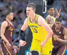  ?? DAVID J. PHILLIP — THE ASSOCIATED PRESS ?? Michigan’s Moritz Wagner (13) had 24 points and 15 rebounds to help the Wolverines beat Loyola-Chicago in the first of Saturday’s semifinal games.