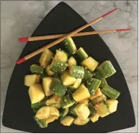  ?? PHOTOS BY CATHY THOMAS ?? Smashing cucumbers before they are tossed is supposed to help the cucumber absorb the dressing more generously.