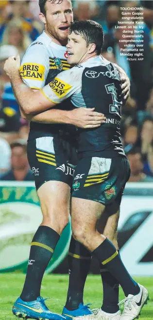  ?? Picture: AAP ?? TOUCHDOWN: Gavin Cooper congratula­tes teammate Kane Linnett on his try during North Queensland’s comprehens­ive
victory over Parramatta on Monday night.