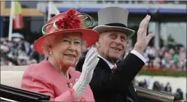  ?? ASSOCIATED PRESS FILE PHOTOS ?? Britain’s Queen Elizabeth II with Prince Philip arrive by horse-drawn carriage in the parade ring on the third day, traditiona­lly known as Ladies Day, of the Royal Ascot horse race meeting at Ascot, England.