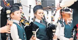  ?? ?? Performing A school pipe band playing at the championsh­ips