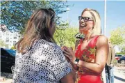  ?? [AP PHOTO] ?? U.S. Senate candidate Kyrsten Sinema speaks to a supporter Tuesday at the Barton Barr Central Library in Phoenix. Sinema and Republican challenger Martha McSally are seeking the Senate seat in Arizona being vacated by Jeff Flake, who is retiring in January.