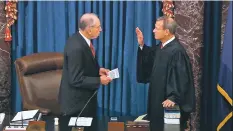  ?? IMAGE FROM SENATE TELEVISION VIA AP ?? From left, Senate President Pro Tem Chuck Grassley, R-Iowa, on Thursday swears in Chief Justice John Roberts as the presiding officer for the impeachmen­t trial of President Donald Trump in the Senate.