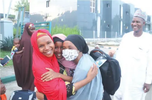  ?? Associated Press ?? ↑
A woman welcomes her daughter, who was evacuated from Sudan, upon her arrival in Abuja, Nigeria, on the weekend.