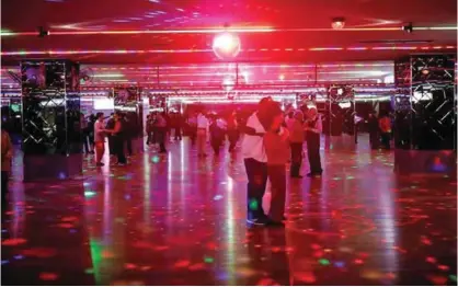  ??  ?? Elderly people dance at the New Hyundai Core “colatec” in Seoul.— Reuters photos