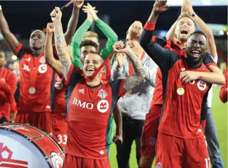  ?? RENE JOHNSTON /TORONTO STAR ?? Scoring hero Sebastian Giovinco, middle, Jozy Altidore, right, and Toronto FC teammates get the party started after Tuesday’s big win at BMO Field.