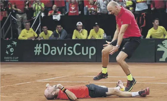  ??  ?? 2 Belgium’s Steve Darcis, left, and captain Johan Van Herck celebrate after Darcis defeated Jordan Thomson to clinch a 3-2 win over Australia in the Davis Cup semi-final in Brussels.