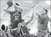  ?? John Munson Associated Press ?? BOSTON UNIVERSITY’S Max Mahoney grabs a rebound over Colgate’s Jordan Burns in title game.