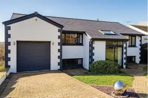  ??  ?? The contempora­ry home on Westport Road, Swansea, with Gower coast views, which is on the market for £650,000 with Fine & Country Swansea.