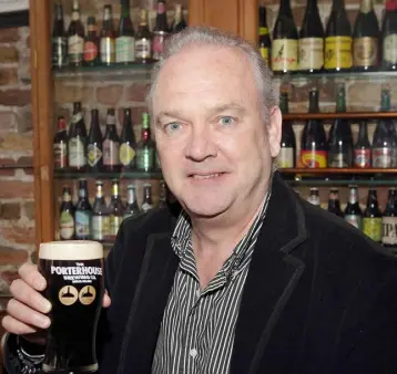  ??  ?? BEER AND THE BAR: Oliver Hughes enjoys a craft beer, and below, mourners attending his funeral at the Royal Hospital in Kilmainham in Dublin