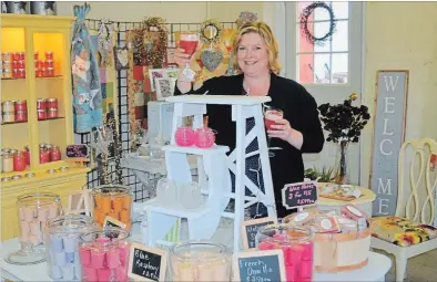  ?? PAT MARCHEN/SPECIAL TO THE EXAMINER ?? Jennifer Foshay in her shop Allen Wick Candles and Gifts, in the old school in Keene. She makes the candles from soy or paraffin.