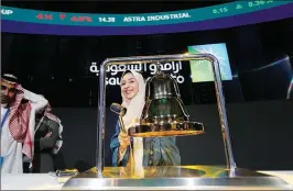  ?? ASSOCIATED PRESS ?? AN EMPLOYEE of Saudi Arabia’s state-owned oil company rings the stock bell as she celebrates during the official ceremony marking the debut of Aramco’s initial public offering (IPO) on the Riyadh’s stock market in Riyadh, Saudi Arabia, Wednesday, Dec. 11.