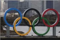  ?? JAE C. HONG — THE ASSOCIATED PRESS ?? A worker is dwarfed by the Olympics Rings on a barge Jan. 17in the Odaiba district of Tokyo.