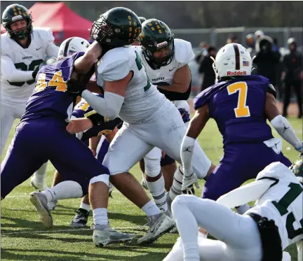  ?? GEORGE SPITERI — FOR MEDIANEWS GROUP, FILE ?? Birmingham Groves’ Avery Gach (74) opens a hole in the Falcons’ playoff game against Warren De La Salle last fall. Gach recently earned his first five-star rating as a prospect, and picked up several key offers.