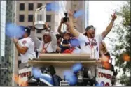  ?? BRETT COOMER - HOUSTON CHRONICLE VIA AP ?? Houston Mayor Sylvester Turner, left, holds up the World Series trophy as the Houston Astros World Series MVP George Springer (4) cheers during parade honoring the World Series baseball champions, Friday, Nov. 3, 2017, in Houston.