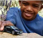 ??  ?? Kids can play with a Tesla Roadster, top, made from recycled materials