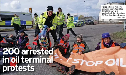  ?? JACOB KING ?? Police officers remove activists from Just Stop Oil taking part in a blockade at the Kingsbury Oil Terminal, Warwickshi­re