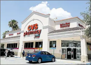  ?? AP/ ALAN DIAZ ?? CVS customers visit a store in Hialeah, Fla., in May. The pharmacy chain now faces a lawsuit claiming that it charged customers co- payments for certain prescripti­on drugs that exceed the cost of medicines.