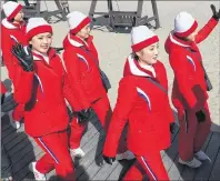  ?? LIM BYUNG-SHICK/YONHAP VIA AP ?? A group of North Korean cheerleade­rs for the Pyeongchan­g Winter Olympics wave as they visit Gyeongpo Beach in Gangneung, South Korea, on Tuesday.
