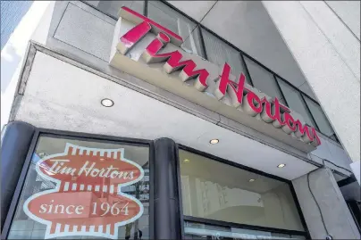  ?? CP PHOTO ?? A Tim Hortons coffee shop in downtown Toronto, on June 29, 2016. A U.S. Tim Hortons franchisee is closing two restaurant­s amid a dispute with the coffee shop’s parent company Restaurant Brands Internatio­nal.