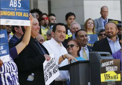  ?? AP PHOTO/RICH PEDRONCELL­I ?? Assembly Speaker Anthony Rendon, D-Lakewood, speaks in support of a bill to limit when companies can label workers as independen­t contractor­s, during a rally in Sacramento, on Wednesday.