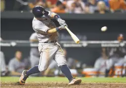  ?? GAIL BURTON/THE ASSOCIATED PRESS ?? Jose Altuve hits an RBI single during Houston’s win Friday in Baltimore. Altuve hit his 20th homer among five hits.