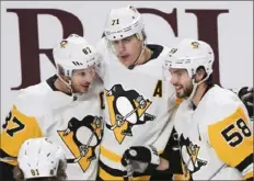  ?? Associated Press ?? Sidney Crosby, Evgeni Malkin, center, and Kris Letang will account for 31% of the Penguins’ salary cap in the new season.