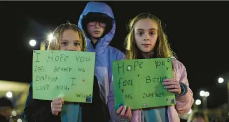  ?? JOHN C. CLARK/AP ?? Willow Crawford, left, her sister Ava, right, and friend Kaylynn Vestre express support for Richneck Elementary teacher Abby Zwerner on Jan. 9.