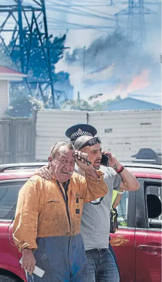  ?? Photo: IAIN McGREGOR/FAIRFAX NZ ?? In vain: Bruce Hobbs flees after trying to fight the fire with a garden hose. His house was destroyed. ‘‘I thought something would be half all right, but no,’’ he said.