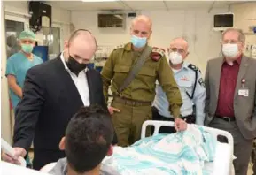  ?? PHOTOS: GETTY IMAGES / AMOS BEN GERSHOM / ISRAEL GPO ?? Leader: Bennett with a soldier wounded in a counter-terror op