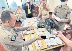  ?? POLICE PHOTO ?? Police search the office of then Department of National Parks, Wildlife and Plant Conservati­on head, Rutchada Suriyakul Na Ayutya.