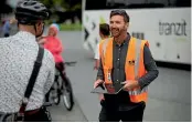  ?? DAVID UNWIN/STUFF ?? Palmerston North City Council urban designer Dave Charnley chats with cyclists at Palmerston North’s i-site.
