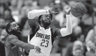  ?? VERNON BRYANT/TRIBUNE NEWS SERVICE ?? The Boston Celtics' Kyrie Irving (11) knocks the ball out of the hands of the Dallas Mavericks' Wesley Matthews (23) in Dallas on Monday.