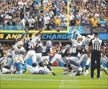  ?? Gina Ferazzi Los Angeles Times ?? GREG ZUERLEIN of Dallas kicks a game-ending, 56-yard field goal as time expires to beat the Chargers 20-17 in front of 70,240 at SoFi Stadium. “We’ll grow from this,” Chargers coach Brandon Staley said.