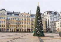  ?? EFREM LUKATSKY AP ?? Ukraine’s main Christmas tree stands in the desolate St. Sophia square in Kyiv on Saturday after the city was hit by airstrikes.