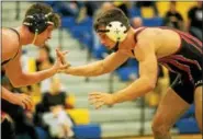  ?? NATE HECKENBERG­ER — FOR DIGITAL FIRST MEDIA ?? Boyertown’s Evan Mortimer looks to attack Downingtow­n West’s Pat Cusak in a 5-2 win at 160 pounds.