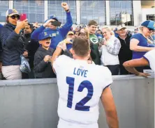  ?? Dustin Satloff / Getty Images ?? San Jose State quarterbac­k Josh Love greets Spartans fans who made the trip to West Point after the win over Army.