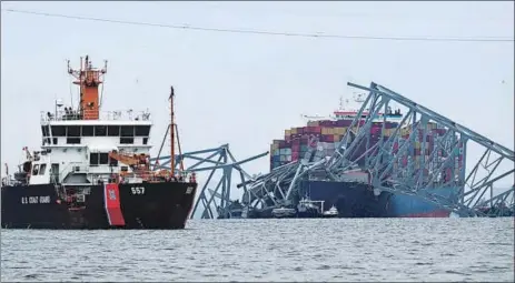  ?? AFP ?? A US Coast Guard vessel (left) patrols near the collapsed Francis Scott Key Bridge after it was struck by the container ship Dali in Baltimore, Maryland, on Wednesday