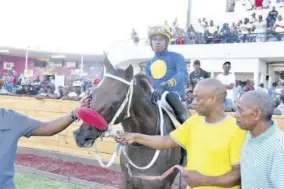  ?? ?? Trainer Paul Swaby (second right) and his charge Kem in the winners’ enclosure after victory in Division Two of the George Hosang Trophy on Saturday, February 3, 2024.