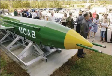  ?? THE ASSOCIATED PRESS FILE PHOTOS ?? A group gathers around a GBU-43B, or massive ordnance air blast (MOAB) weapon, on display at the Air Force Armament Museum on Eglin Air Force Base near Valparaiso, Fla.