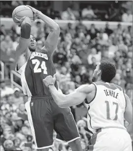  ?? Nick Wass
Associated Press ?? KOBE BRYANT FADES AWAY on a jumper against Washington’s Garrett Temple. Bryant made 10 of 24 shots in his first 30-point game in almost a year.