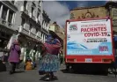  ?? Aizar Raldes/AFP/Getty Images ?? A mobile vaccinatio­n and testing medical unit in La Paz, Bolivia, where long Covid is going largely undocument­ed. Photograph: