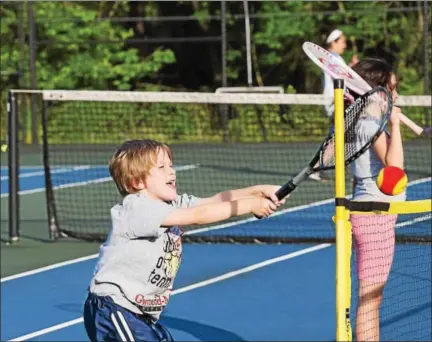  ?? RACHEL WISNIEWSKI/FOR DIGITAL FIRST MEDIA ?? Zack Seiders, 6, hits a ball over the net. This is his second year attending Touch of Tennis and, as he is on the younger side of participan­ts,