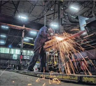  ?? CP PHOTO ?? Fabricator Mike Caldarino uses a grinder on steel stairs being manufactur­ed for a high school in Redmond, Wash., at George Third &amp; Son Steel Fabricator­s and Erectors, in Burnaby, B.C., on March 29.