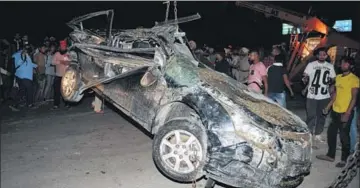  ?? PARDEEP PANDIT/HT ?? A crane lifting the mangled remains of a car after a gravellade­n tipper overturned on it near PAP Chowk in Jalandhar on Sunday. A woman and two children died in the freak accident.