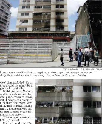  ?? ARIANA CUBILLOS — THE ASSOCIATED PRESS ?? Press members wait as they try to get access to an apartment complex where an allegedly armed drone crashed, causing a fire, in Caracas, Venezuela, Sunday.