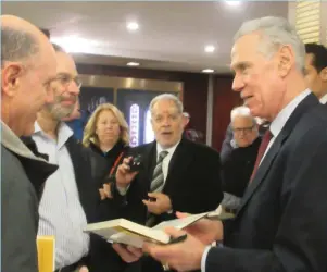  ?? (Howard Blas) ?? ART SHAMSKY (right) – the former Jewish MLB player who was a member of the 1969 World Series-winning New York Mets and the manager of the Israel Baseball League’s Modi’in Miracle in 2007 – signs copies of his book for fans at last week’s ‘Jews in...