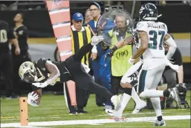  ?? AP photo ?? Saints running back Alvin Kamara carries to the one yard line as the Eagles defensive back Tre Sullivan pursues in the second half in New Orleans on Sunday.