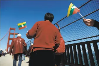  ?? Photos by Scott Strazzante / The Chronicle ?? A group walks across the Golden Gate Bridge in solidarity with the people of Myanmar.